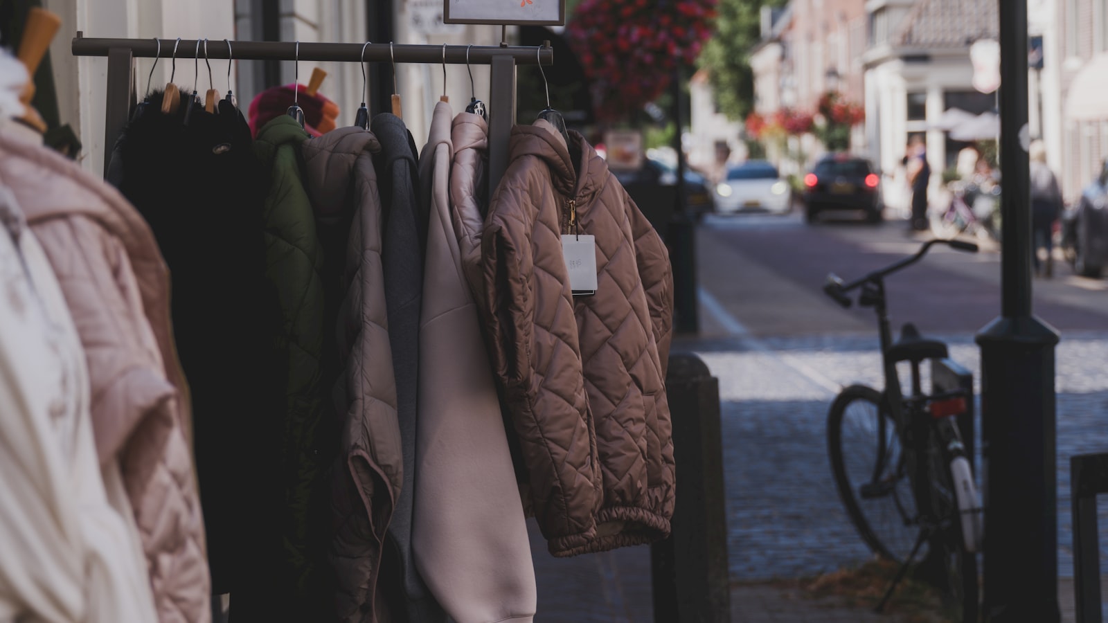 Clothing displayed on a street rack for an article about activism apparel and wearing values