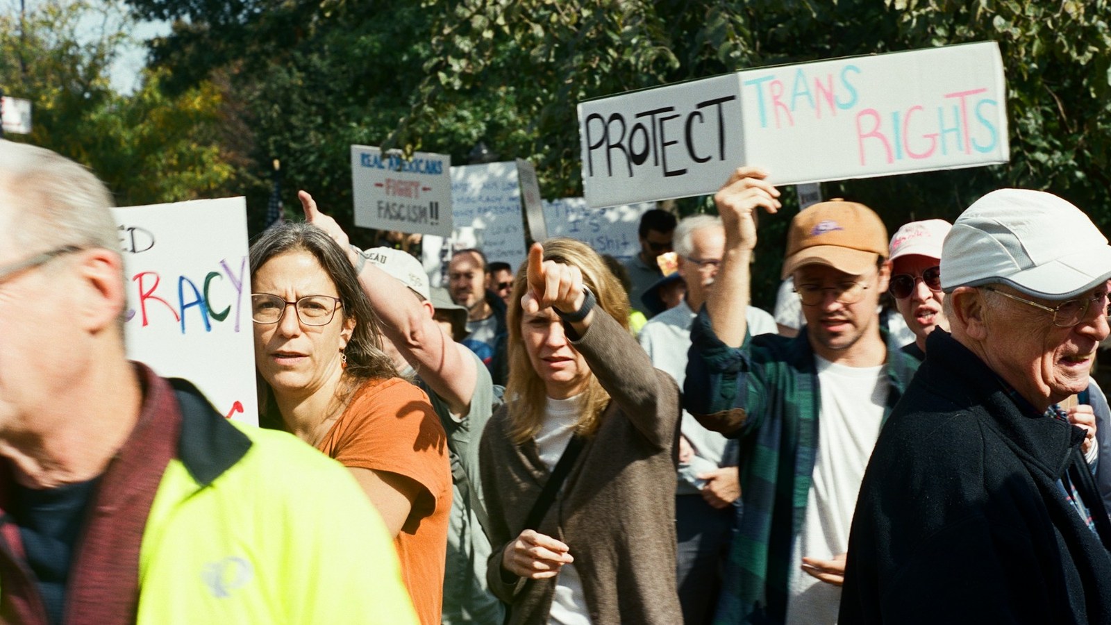 People marching with protest signs for an article about spiritual bypassing activism and justice