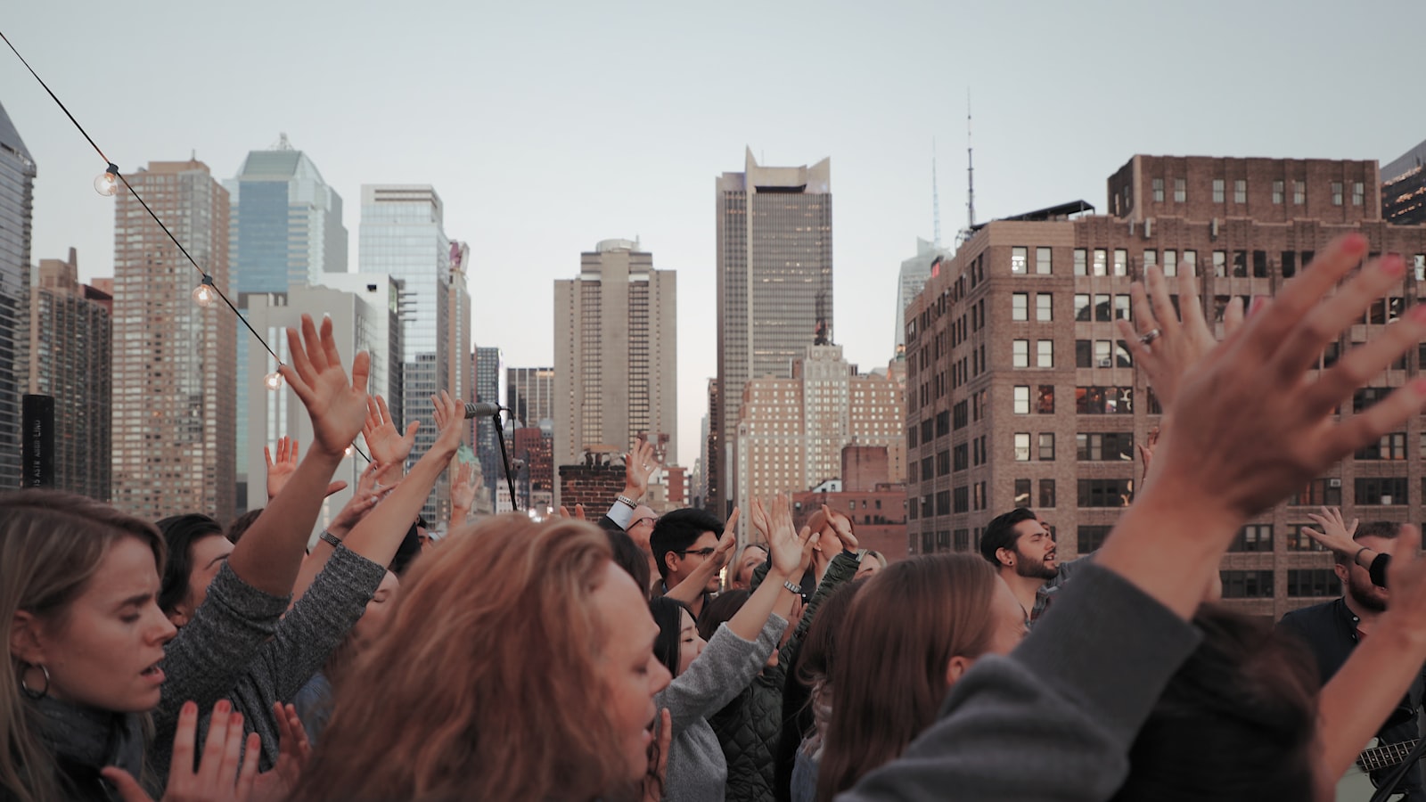 People raising hands together as a symbol of spiritual activism and positive action